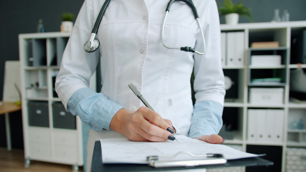 An at-home genetic testing kit alongside consultation paperwork